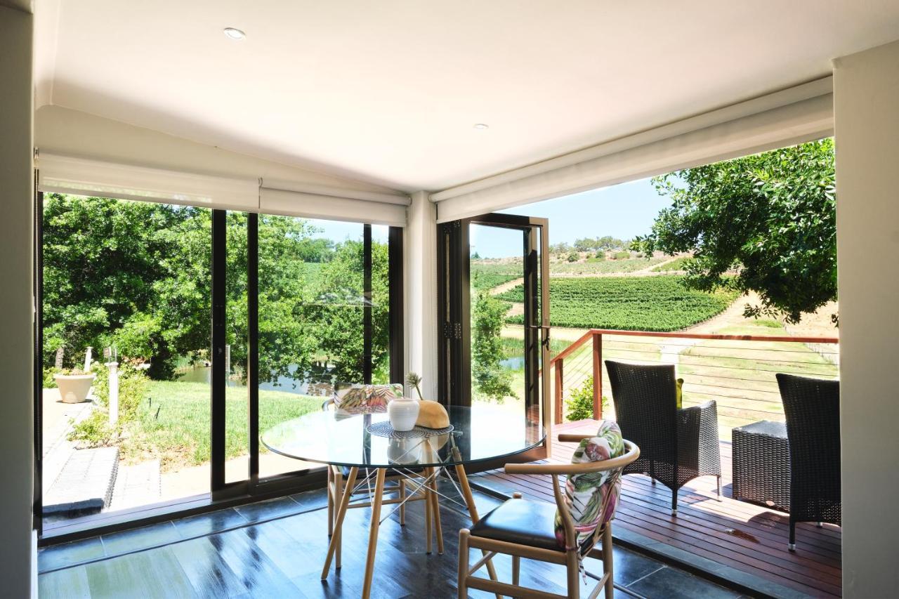 Alluvia Boutique Winery & Luxury Accommodation Stellenbosch Ngoại thất bức ảnh A room with a view of the vineyards